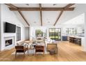 Open concept living room with hardwood floors, fireplace, and exposed wooden beams at 6836 N 13Th Pl # A, Phoenix, AZ 85014