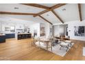 Open concept living room with hardwood floors, exposed beams, and kitchen island at 6836 N 13Th Pl # A, Phoenix, AZ 85014