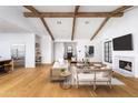 Open concept living room with hardwood floors, fireplace, and exposed wooden beams at 6836 N 13Th Pl # A, Phoenix, AZ 85014