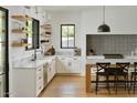 Modern kitchen with white cabinets, marble countertops and island at 6836 N 13Th Pl # B, Phoenix, AZ 85014