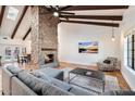 Open living space featuring a stone fireplace and comfy seating at 7211 E Sunnyside Dr, Scottsdale, AZ 85260