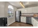 Updated kitchen with white cabinets, stainless steel appliances, and wood flooring at 930 N Mesa Dr # 2037, Mesa, AZ 85201
