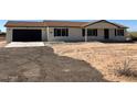 Front view of a new construction home with a garage at 13419 S Hermit Rd, Buckeye, AZ 85326