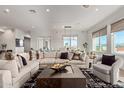 Living room with sectional sofa, city view, and hardwood floors at 6166 N Scottsdale Rd # C3006, Paradise Valley, AZ 85253