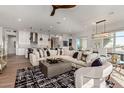 Open concept living space with sectional sofa and hardwood floors at 6166 N Scottsdale Rd # C3006, Paradise Valley, AZ 85253