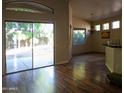 Bright living room with hardwood floors, sliding glass doors, and backyard access at 15151 N 100Th Way, Scottsdale, AZ 85260