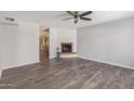 Living room with fireplace and wood-look flooring at 1425 E Desert Cove Ave # 43, Phoenix, AZ 85020