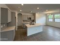 Modern kitchen with island, gray cabinets, and tile flooring at 24066 N 162Nd Ln, Surprise, AZ 85387