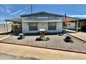 Single-wide manufactured home with American flag at 305 S Val Vista Dr # 37, Mesa, AZ 85204