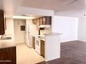 Kitchen with breakfast bar and view into living room at 4608 W Maryland Ave # 144, Glendale, AZ 85301