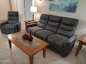 Relaxing living room featuring a comfortable sofa and recliner at 14950 W Mountain View Blvd # 1111, Surprise, AZ 85374