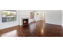 Bright living room with hardwood floors, fireplace, and large windows at 845 W Edgemont Ave, Phoenix, AZ 85007