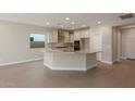 Modern kitchen with island, stainless steel appliances, and granite countertops at 2869 N Coronado Dr, Florence, AZ 85132