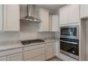 Modern kitchen features stainless steel appliances and granite countertops at 2869 N Coronado Dr, Florence, AZ 85132