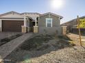 Front yard view of a single-story home with gray exterior and a paved walkway at 4657 N 177Th Ln, Goodyear, AZ 85395