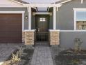 Front entry with stone pillars, wrought-iron gate, and a pergola at 4657 N 177Th Ln, Goodyear, AZ 85395