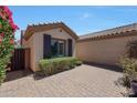 Courtyard entry with brick pavers and a gated side yard at 41333 N Belfair Way, Anthem, AZ 85086
