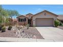 Single-story home with desert landscaping and a two-car garage at 41333 N Belfair Way, Anthem, AZ 85086