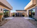 Private courtyard with water feature, potted plants, and access to multiple rooms at 37200 N Cave Creek Rd # 1005, Scottsdale, AZ 85262