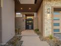 Private gated entry with modern metal gate and stone walls at 37200 N Cave Creek Rd # 1005, Scottsdale, AZ 85262