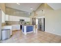 Kitchen with stainless steel appliances, island, and white cabinets at 7216 W Irma Ln, Glendale, AZ 85308