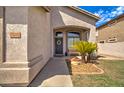Front porch with a purple door, wreath, bench, and potted plant at 7216 W Irma Ln, Glendale, AZ 85308