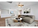 Spacious living room with a sectional sofa and a modern coffee table at 31777 N Sundown Dr, San Tan Valley, AZ 85143