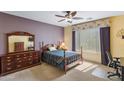 Bright bedroom with a double bed, dresser, and home office space at 42609 W Milky Way, Maricopa, AZ 85138