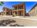Two-story home with a balcony and Spanish-style architecture at 853 E Agua Fria Ln, Avondale, AZ 85323