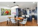 Elegant dining room with a large wooden table and modern chandelier at 7818 E Northland Dr, Scottsdale, AZ 85251