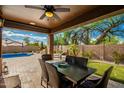 Covered patio with dining table and view of the pool at 5222 E Cordia Ln, Cave Creek, AZ 85331