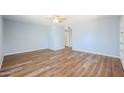 Light blue walls and wood flooring in this spacious bedroom at 2316 E Betty Elyse Ln, Phoenix, AZ 85022