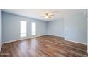 Bright bedroom with light blue walls and wood flooring at 2316 E Betty Elyse Ln, Phoenix, AZ 85022