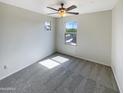 Bright bedroom with carpeted floor and ceiling fan at 2178 N 212Th Ln, Buckeye, AZ 85396