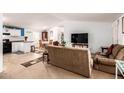 Open concept kitchen and living area with brown couches at 9431 E Coralbell Ave # 172, Mesa, AZ 85208