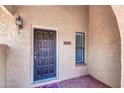 Condo entrance with a dark wood door, small window, and exterior lighting at 10437 N 11Th St # 2, Phoenix, AZ 85020