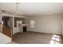Spacious living room with a fireplace and large windows at 9419 W Sheridan St, Phoenix, AZ 85037