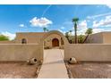 Front view of a charming house with arched entryway at 6023 E Turquoise Ave, Paradise Valley, AZ 85253