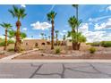 Front view of a beautiful house with palm trees and landscaping at 6023 E Turquoise Ave, Paradise Valley, AZ 85253