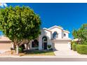 Two-story home with stucco exterior, two-car garage, and manicured lawn at 2242 W Myrtle Dr, Chandler, AZ 85248