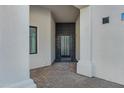 Modern entry with dark-stained front door and brick pavers at 28341 N 112Th Way, Scottsdale, AZ 85262