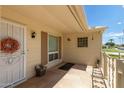 Inviting front entry with a decorative wreath and potted plants at 10318 W Desert Forest Cir, Sun City, AZ 85351