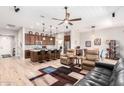 Open kitchen with island and dark brown cabinetry at 16383 W Piccadilly Rd, Goodyear, AZ 85395