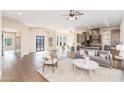 Open floor plan living area with hardwood floors and a cozy seating arrangement at 3518 N Shadow Trl, Mesa, AZ 85207