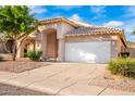 Single-story house with a two-car garage and desert landscaping at 902 E Goldenrod St, Phoenix, AZ 85048