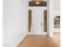 Bright entryway with light hardwood floors and a modern white door at 902 E Goldenrod St, Phoenix, AZ 85048