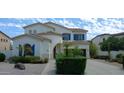 Two-story house with blue shutters, landscaping, and a driveway at 6251 S Moccasin Trl, Gilbert, AZ 85298