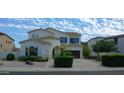 Two-story house with blue accents and landscaped front yard at 6251 S Moccasin Trl, Gilbert, AZ 85298