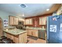 Spacious kitchen featuring granite countertops and ample wood cabinetry at 524 E Cornman Rd, Coolidge, AZ 85128