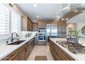 Modern kitchen with stainless steel appliances and ample counter space at 111 E Santa Lucia Ln, Queen Creek, AZ 85140